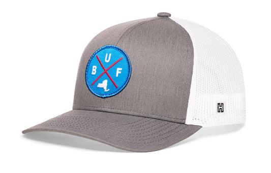 Buffalo Trucker Hat, gray-white snapback showing Haka brandmark on left side of cap.