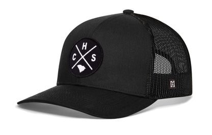 Charleston Trucker Hat, black snapback showing Haka brandmark on left side of cap.