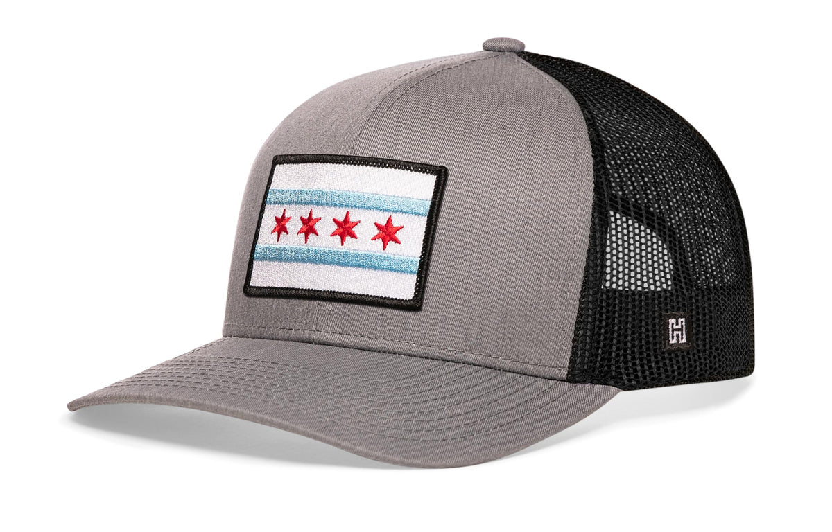 Chicago Trucker Hat, gray-black snapback showing Haka brandmark on left side of cap.
