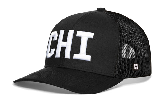 Chicago Trucker Hat, black snapback showing Haka brandmark on left side of cap.