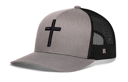 Cross Trucker Hat, gray-black snapback showing Haka brandmark on left side of cap.