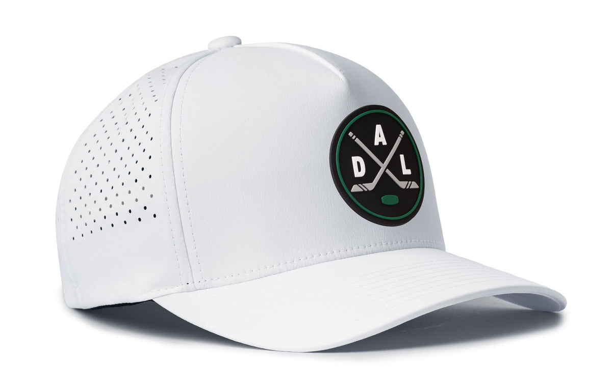 white performance 5-panel hat viewed from the right side, showcasing a bold black, green and gray pvc patch prominently displayed on the front