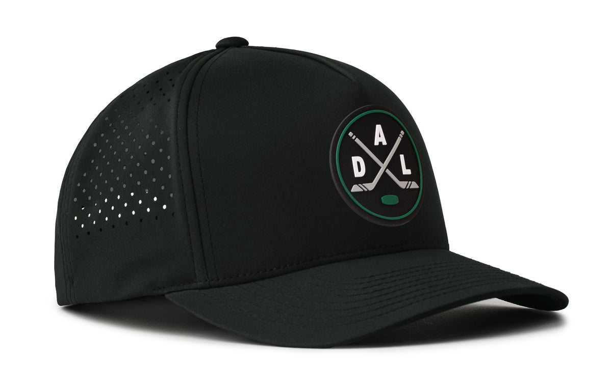 black performance 5-panel hat viewed from the right side, showcasing a bold black, green and gray pvc patch prominently displayed on the front