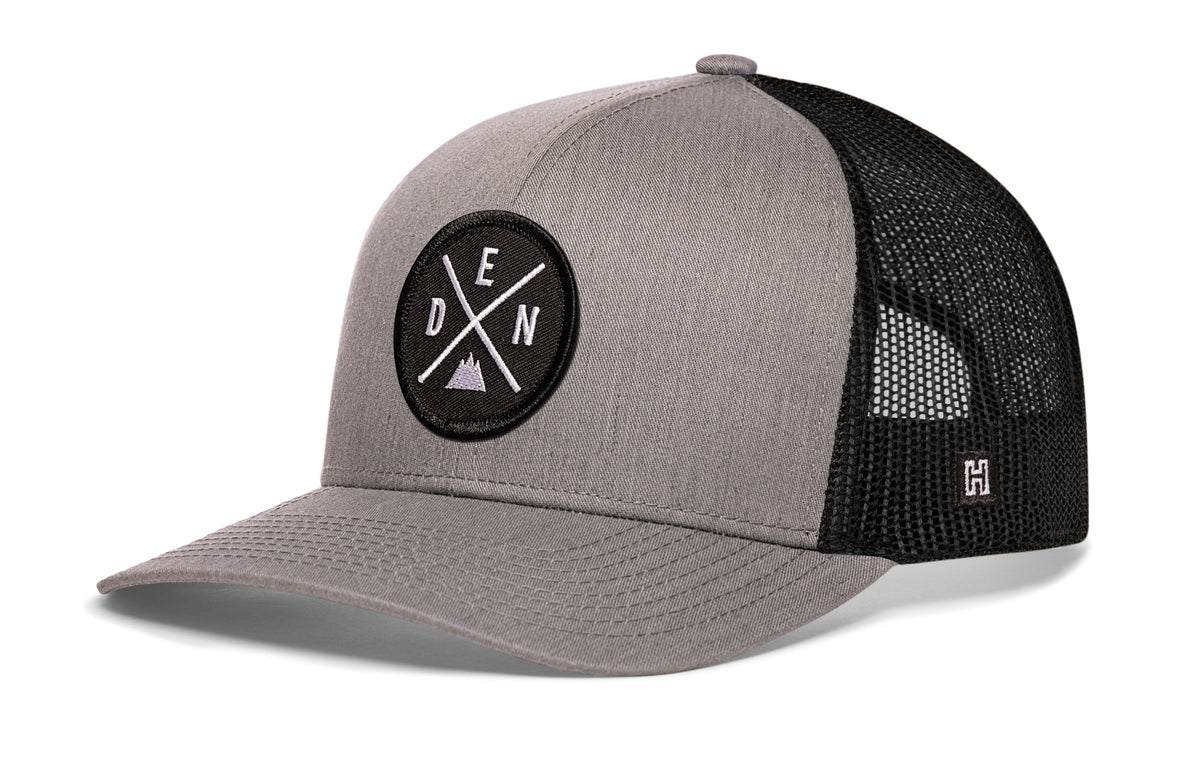Denver Trucker Hat, gray-black snapback showing Haka brandmark on left side of cap.
