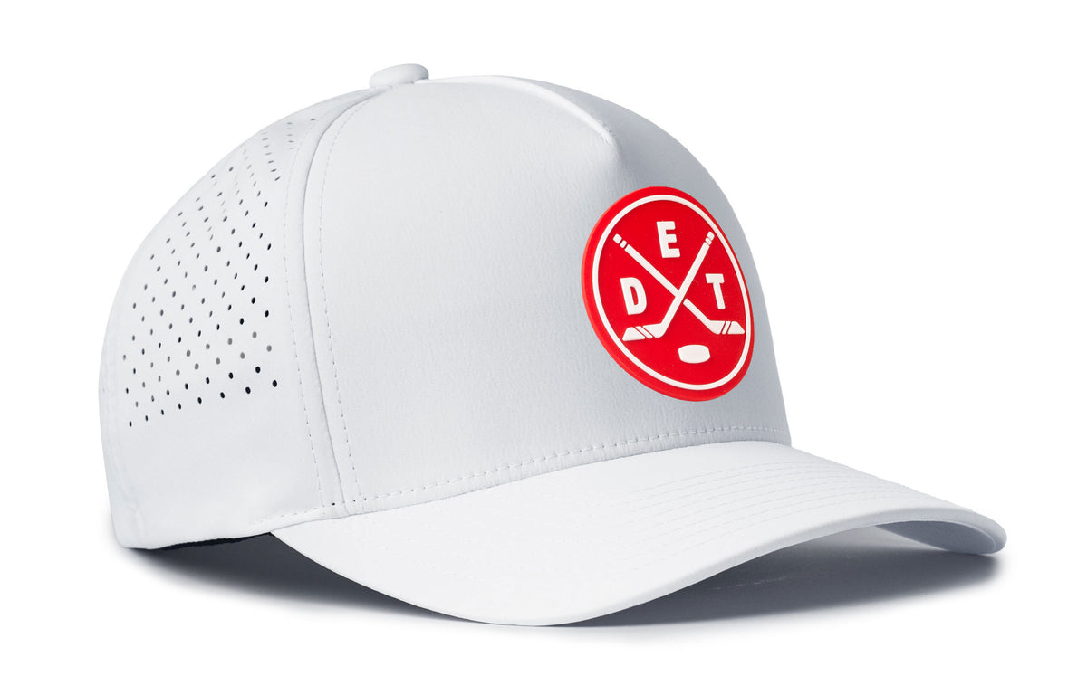 white performance 5-panel hat viewed from the right side, showcasing a bold red and white pvc patch prominently displayed on the front