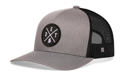 Detroit Trucker Hat, gray-black snapback showing Haka brandmark on left side of cap.