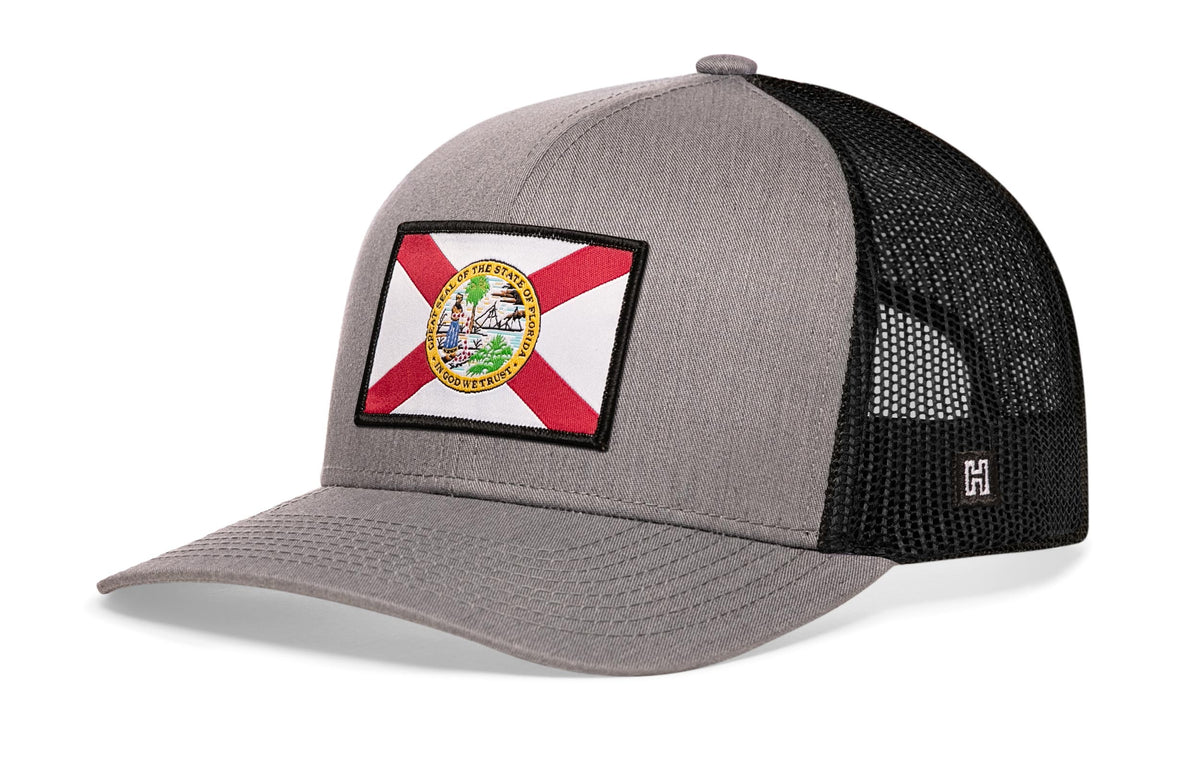 Florida Flag Trucker Hat, gray-black snapback showing Haka brandmark on left side of cap.