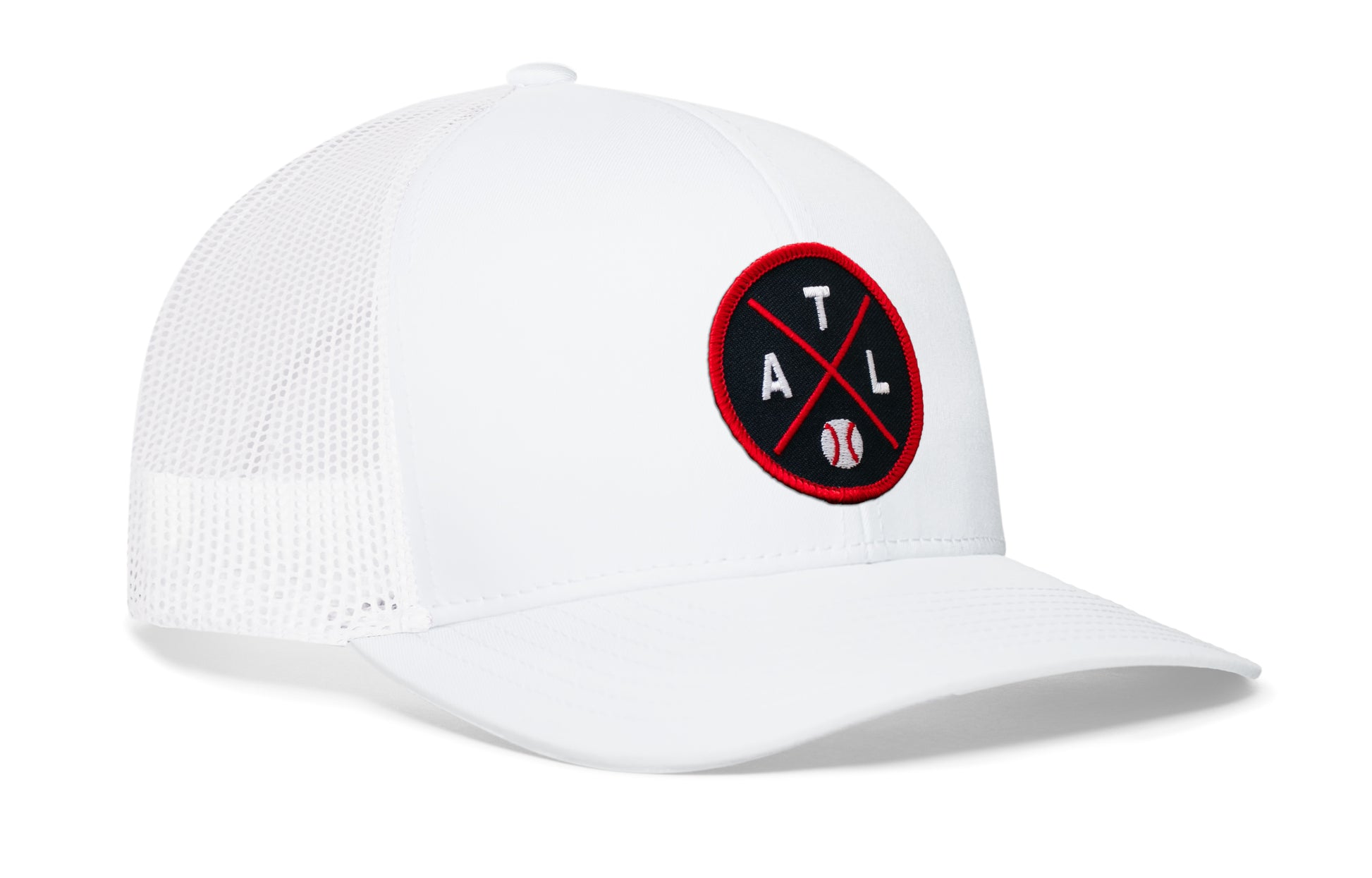 white trucker hat viewed from the right side, showcasing a navy and red baseball embroidered X patch prominently displayed on the front