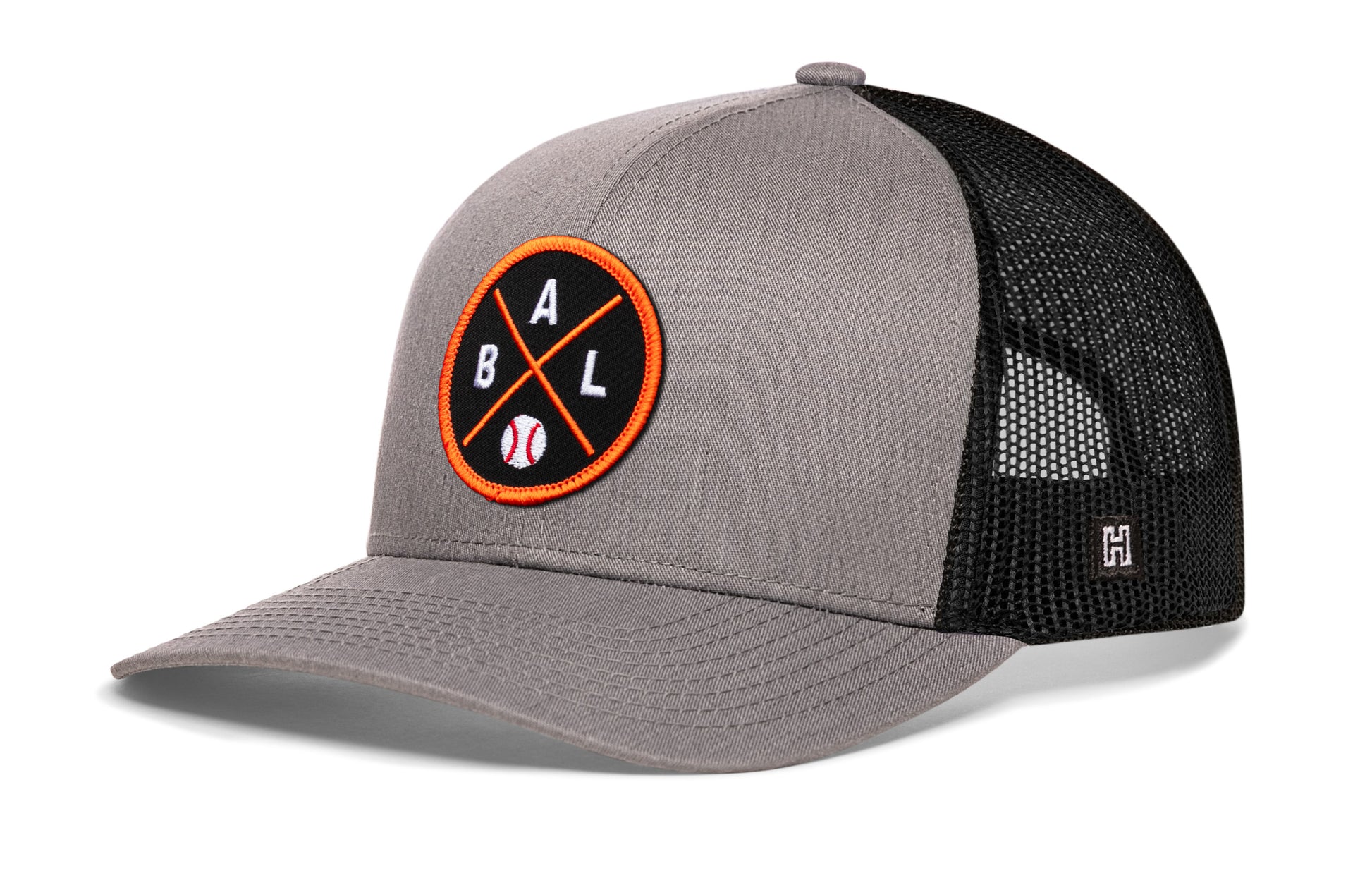 Baltimore trucker hat, gray-black snapback showing Haka brandmark on left side mesh.
Rep Baltimore, MD.
