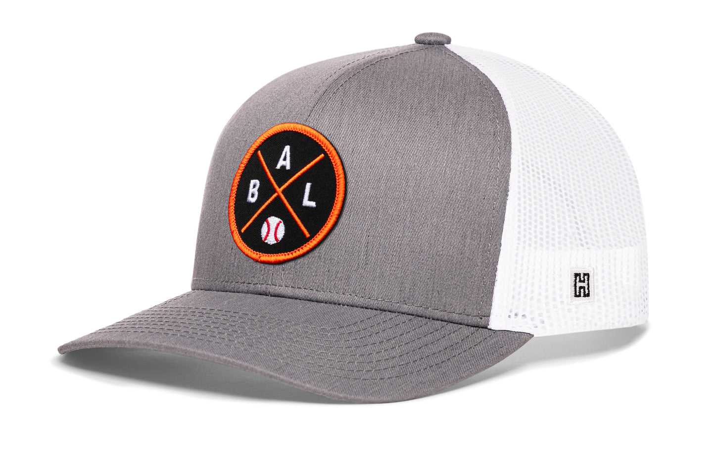 Baltimore trucker hat, gray-white snapback showing Haka brandmark on left side mesh.
Rep Baltimore, MD.