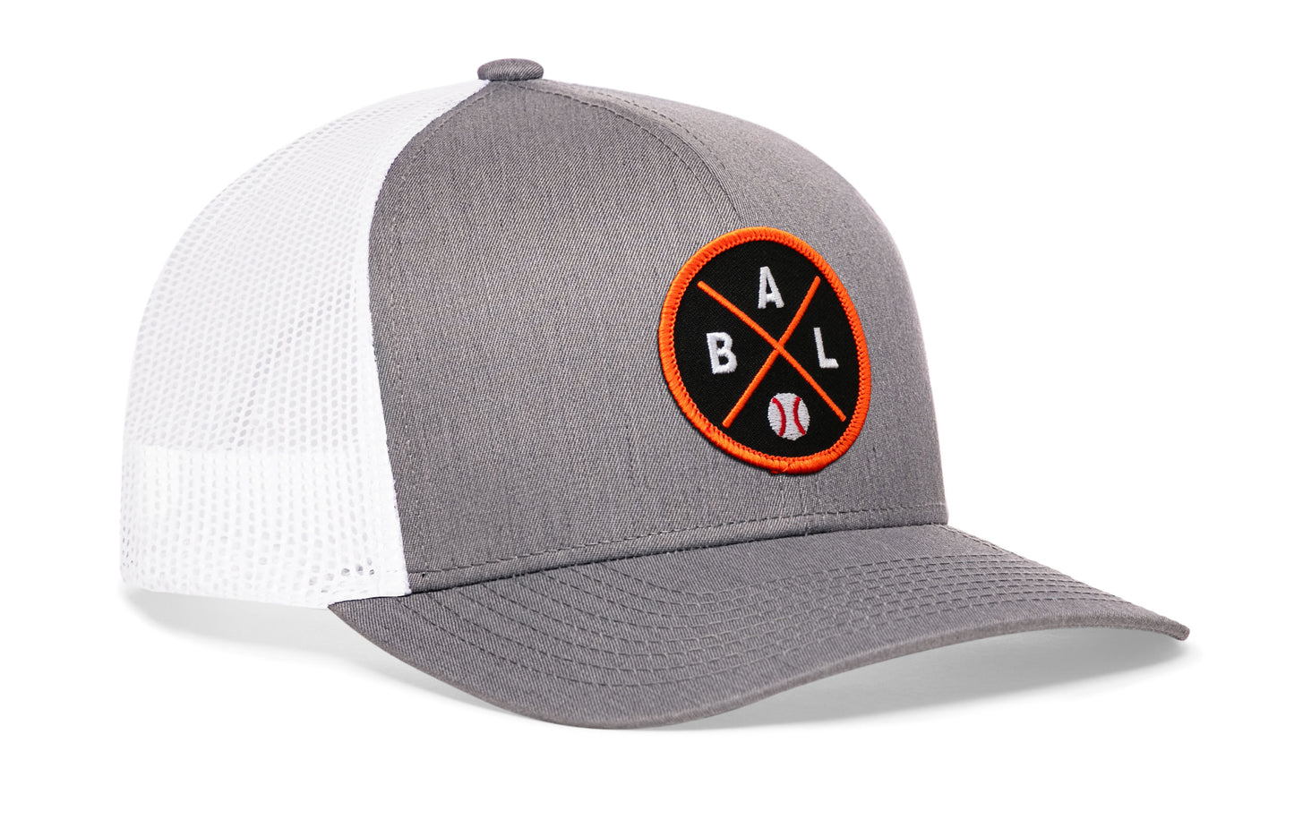 gray-white trucker hat viewed from the right side, showcasing a bold black and orange embroidered X patch prominently displayed on the front