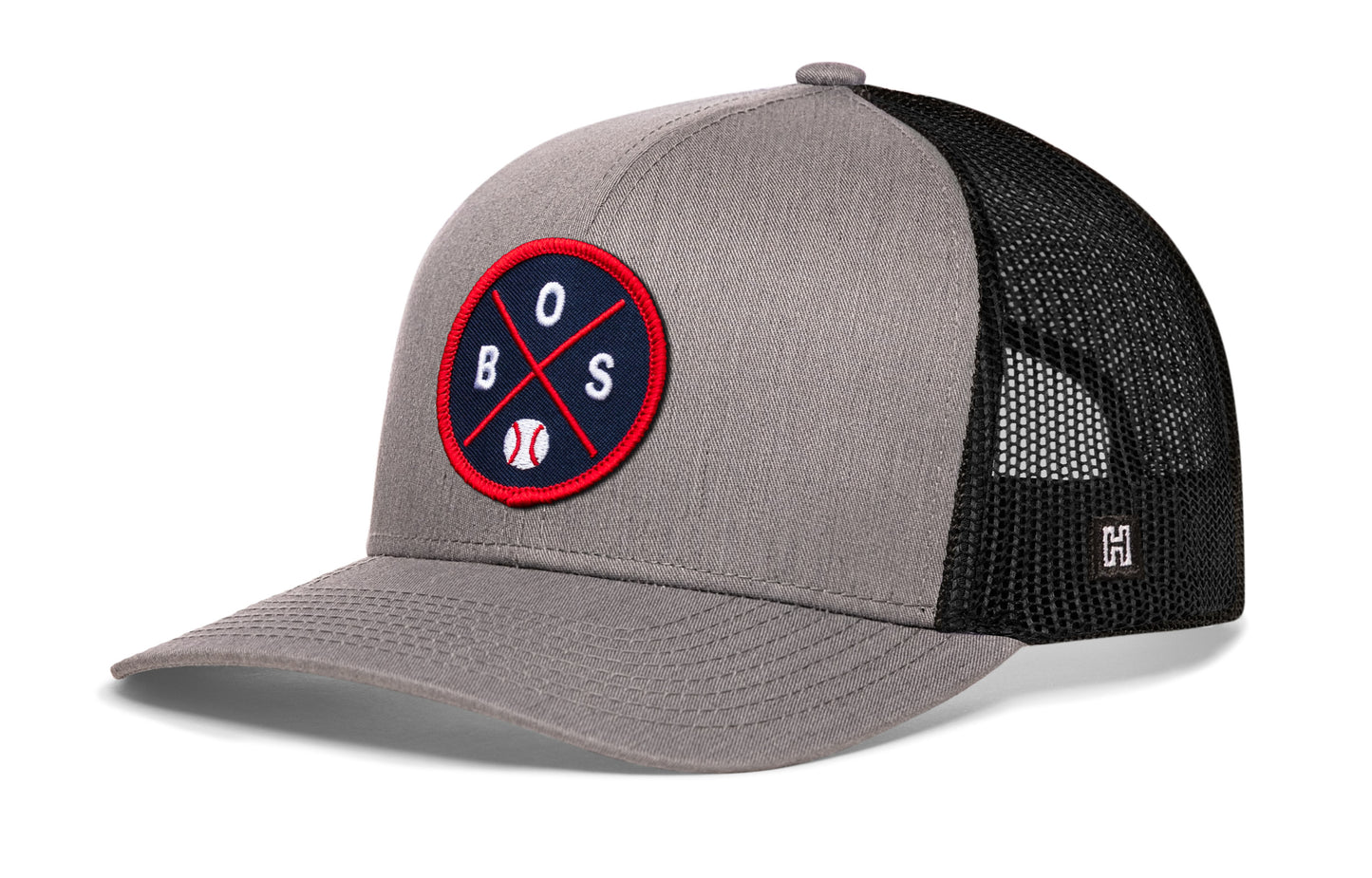 Boston trucker hat, gray-black snapback showing Haka brandmark on left side mesh.
Rep Boston, MA.
