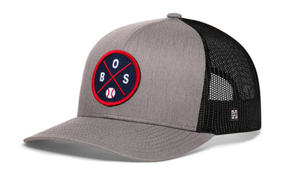 Boston trucker hat, gray-black snapback showing Haka brandmark on left side mesh.
Rep Boston, MA.