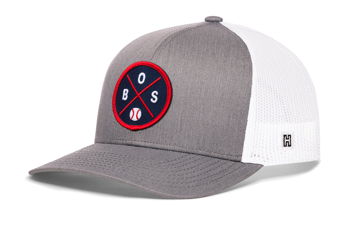 Boston trucker hat, gray-white snapback showing Haka brandmark on left side mesh.
Rep Boston, MA.