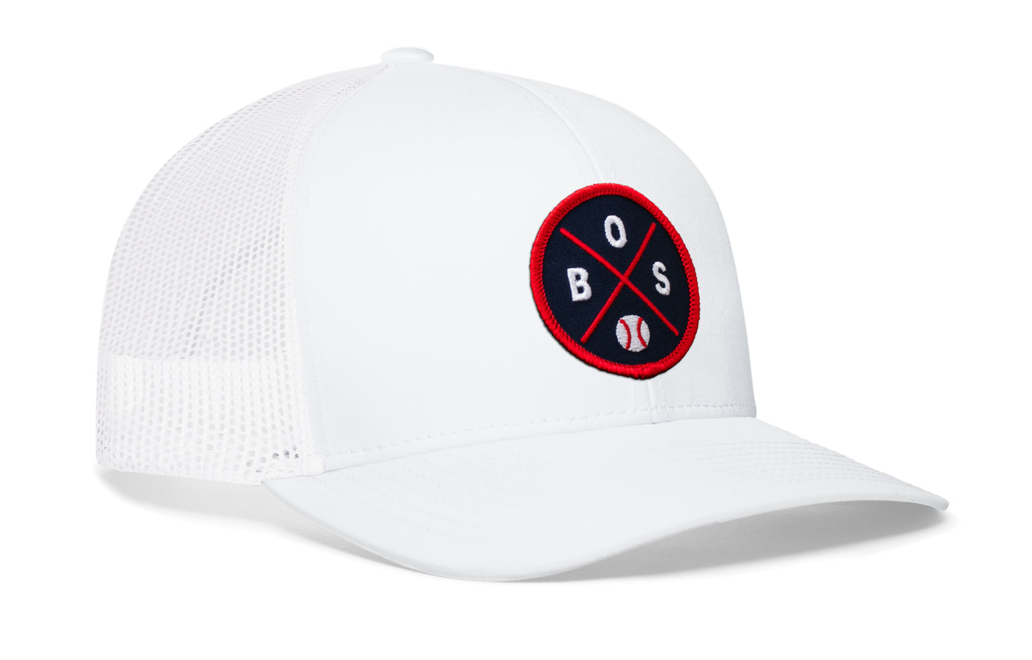 white trucker hat viewed from the right side, showcasing a navy and red baseball embroidered X patch prominently displayed on the front