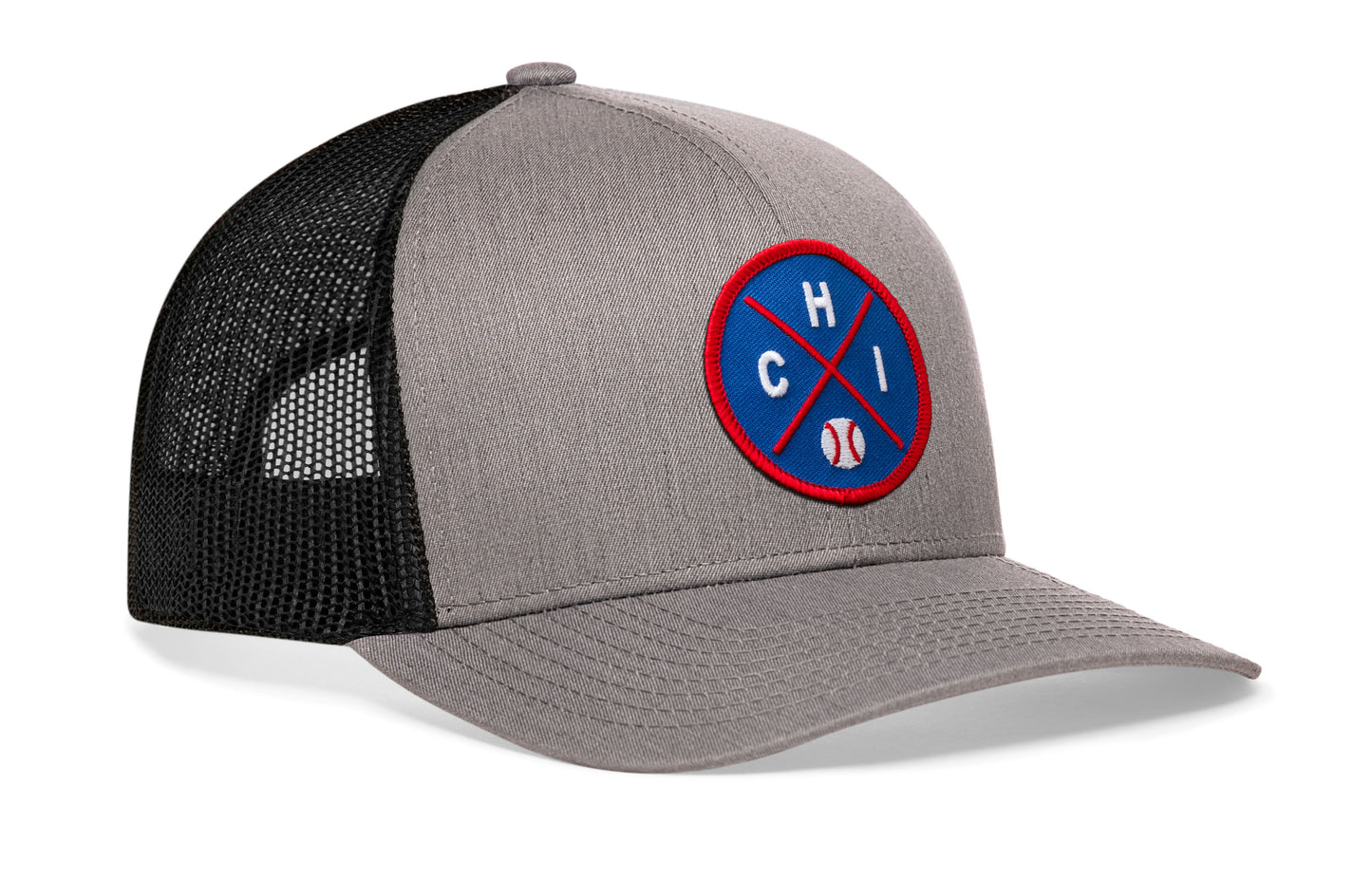 gray-black trucker hat viewed from the right side, showcasing a bold royal and red embroidered X patch prominently displayed on the front