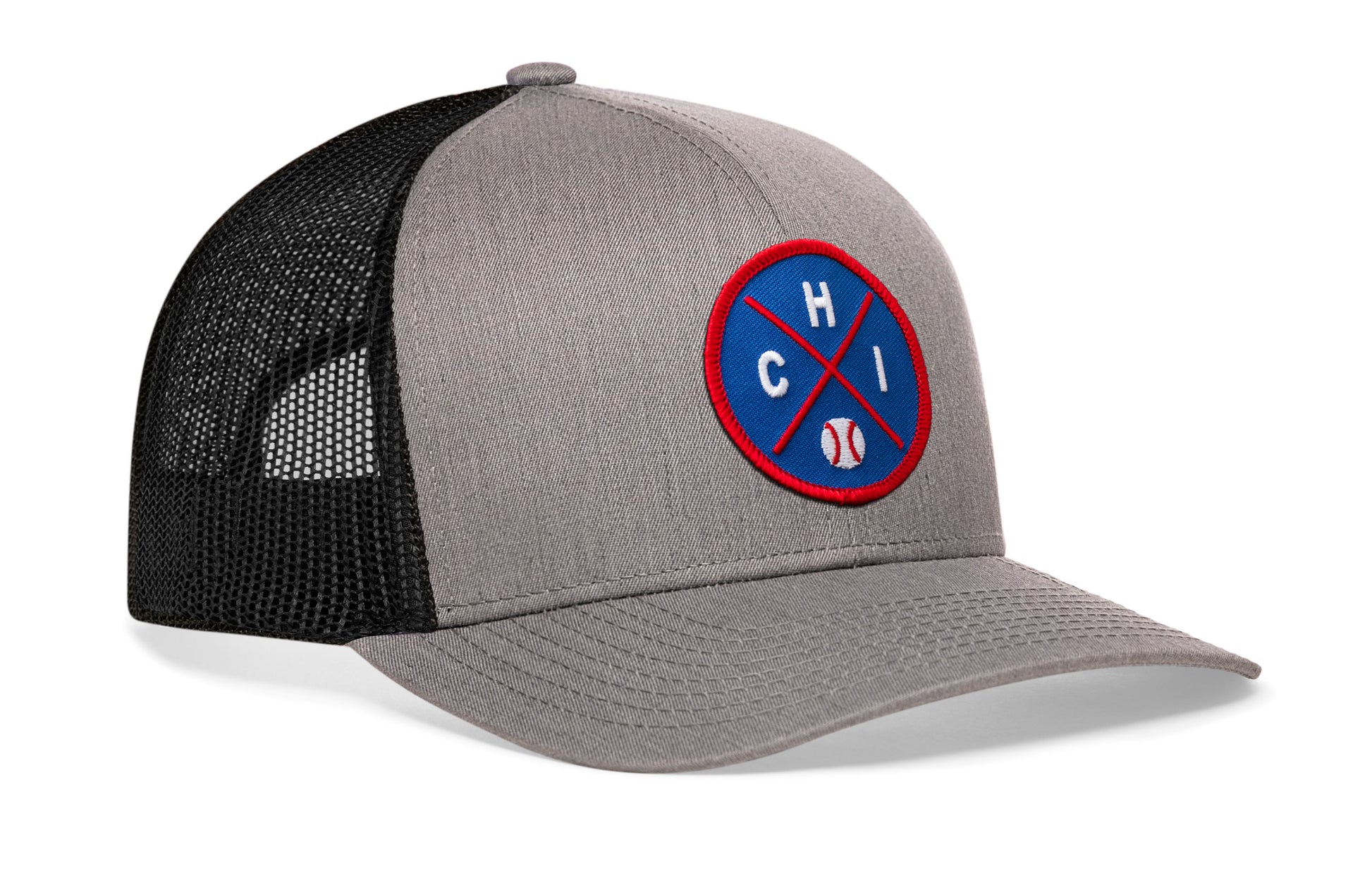 gray-black trucker hat viewed from the right side, showcasing a bold royal and red embroidered X patch prominently displayed on the front