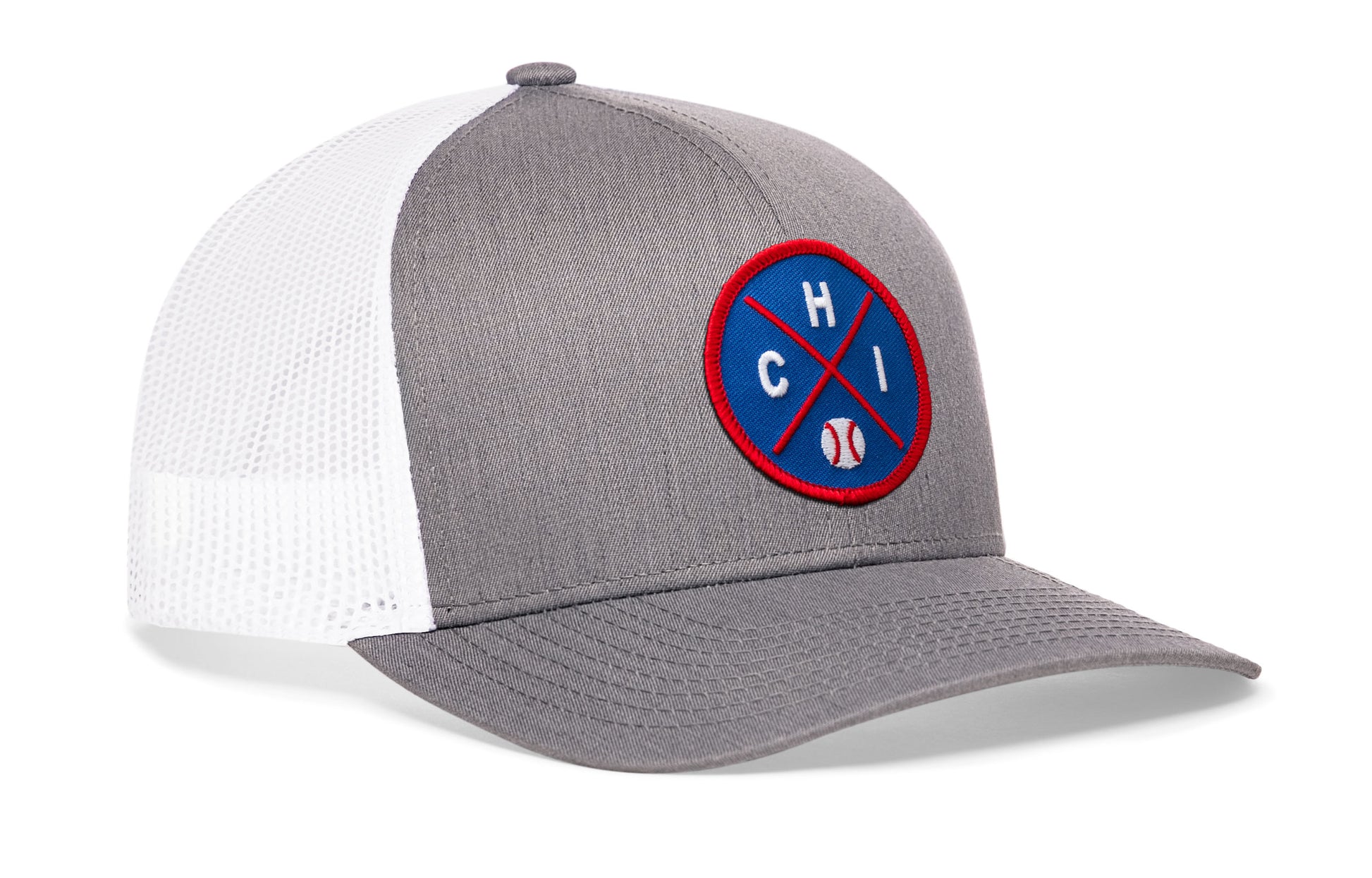gray-white trucker hat viewed from the right side, showcasing a bold royal and red embroidered X patch prominently displayed on the front