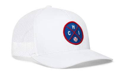 white trucker hat viewed from the right side, showcasing a royal and red baseball embroidered X patch prominently displayed on the front