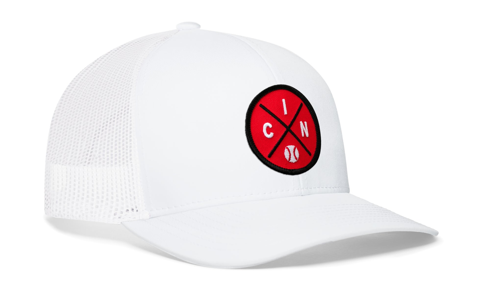 white trucker hat viewed from the right side, showcasing a red and black baseball embroidered X patch prominently displayed on the front