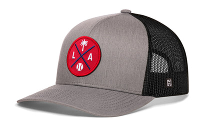 Los Angeles trucker hat, gray-black snapback showing Haka brandmark on left side mesh.
Rep Los Angeles, CA.