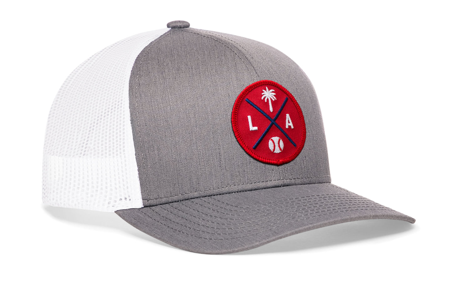 gray-white trucker hat viewed from the right side, showcasing a bold red and navy embroidered X patch prominently displayed on the front