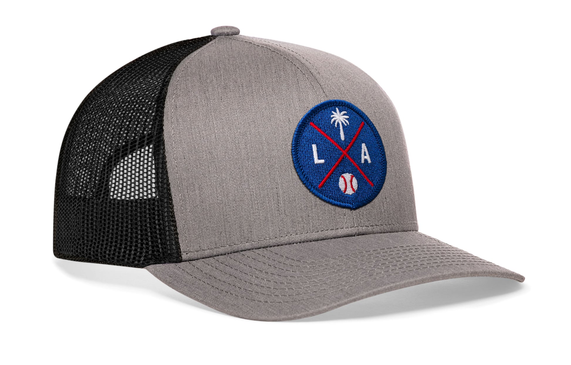 gray-black trucker hat viewed from the right side, showcasing a bold royal and red embroidered X patch prominently displayed on the front