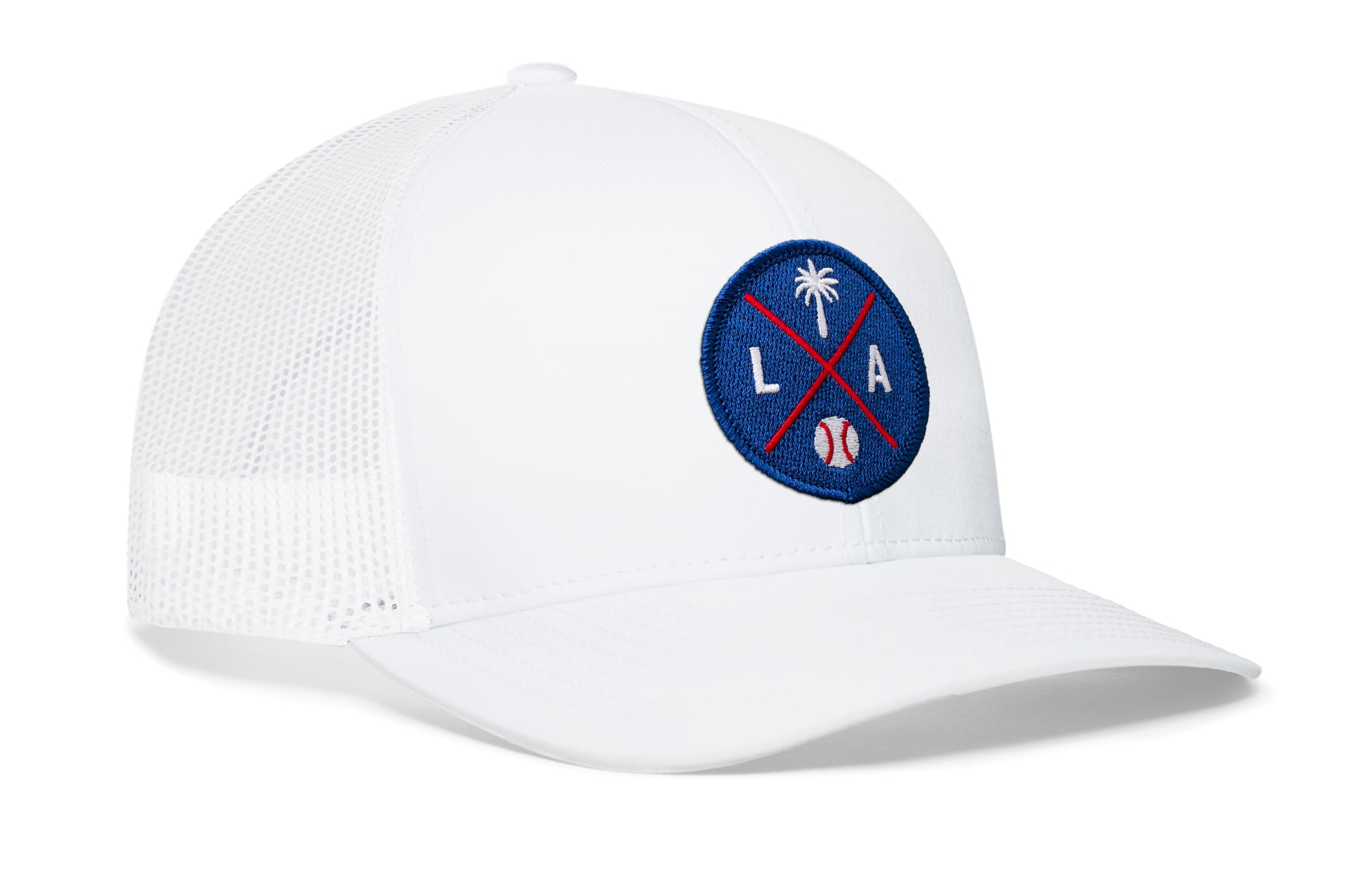 white trucker hat viewed from the right side, showcasing a royal and red baseball embroidered X patch prominently displayed on the front