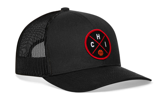 black trucker hat viewed from the right side, showcasing a red and black basketball embroidered X patch prominently displayed on the front