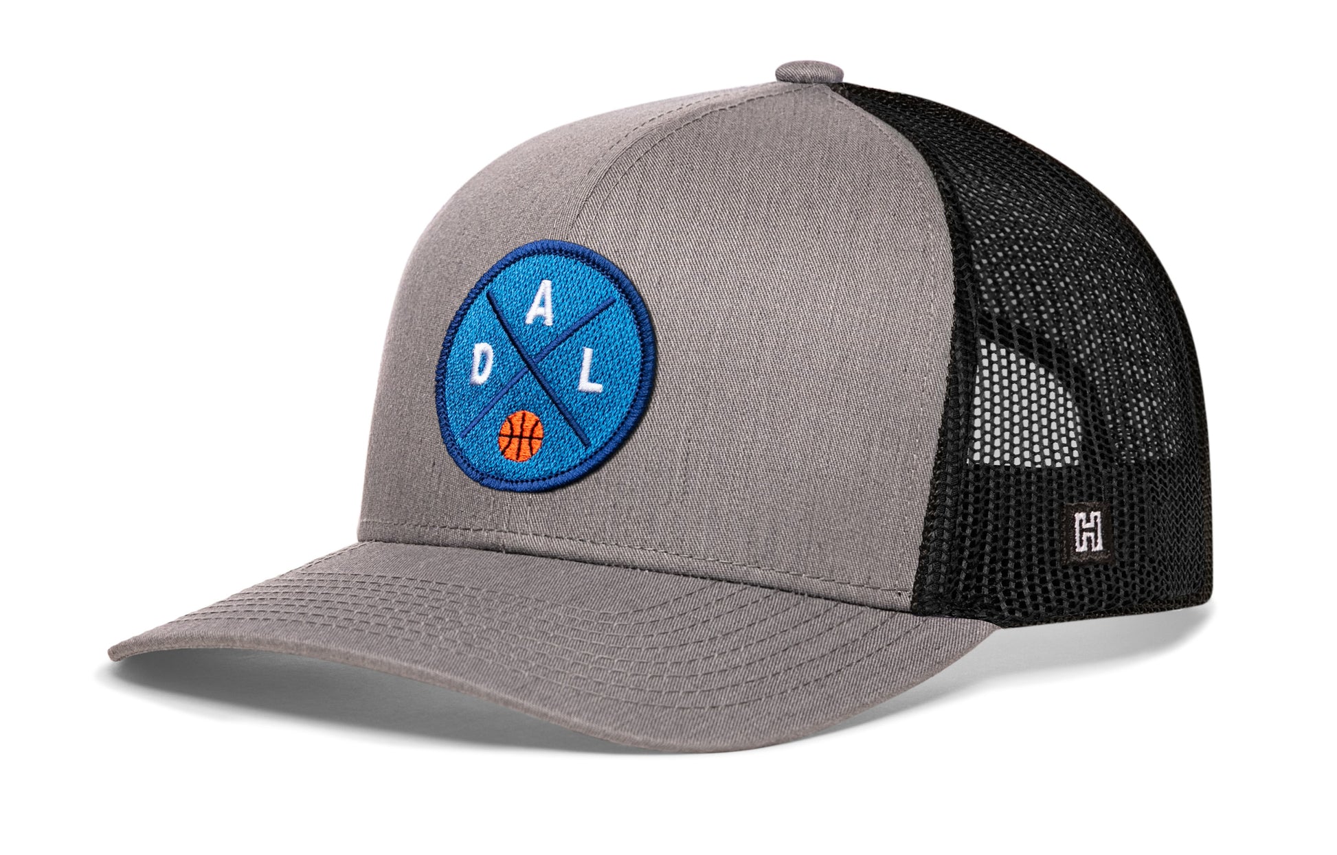 Dallas trucker hat, gray-black snapback showing Haka brandmark on left side mesh.
Rep Dallas, TX basketball.