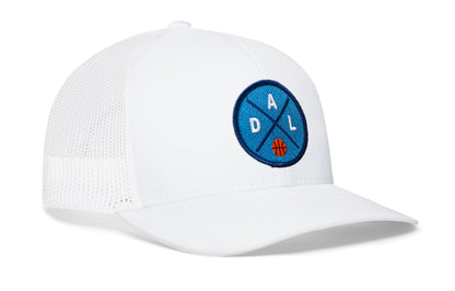white trucker hat viewed from the right side, showcasing a navy and royal basketball embroidered X patch prominently displayed on the front