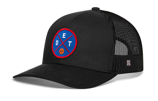 Detroit trucker hat, black snapback showing Haka brandmark on left side mesh of cap.
Rep Detroit, MI basketball.