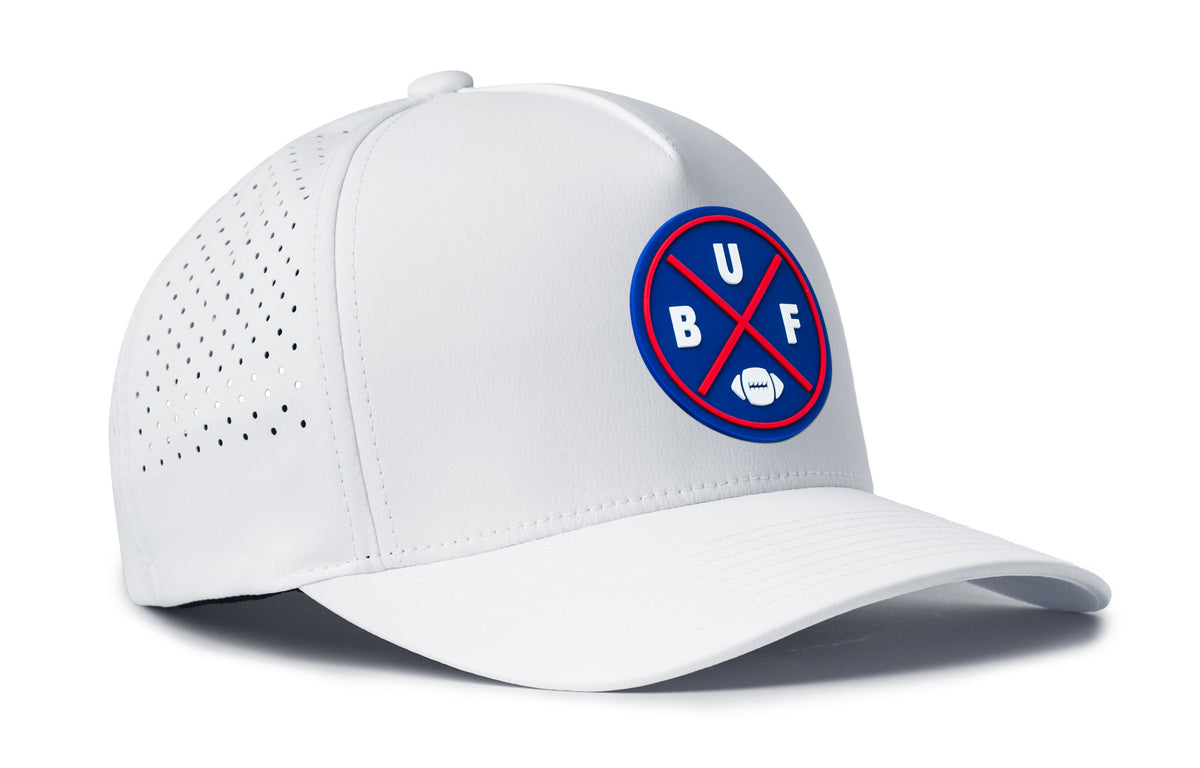 white trucker hat viewed from the right side, showcasing a bold royal and red pvc patch prominently displayed on the front