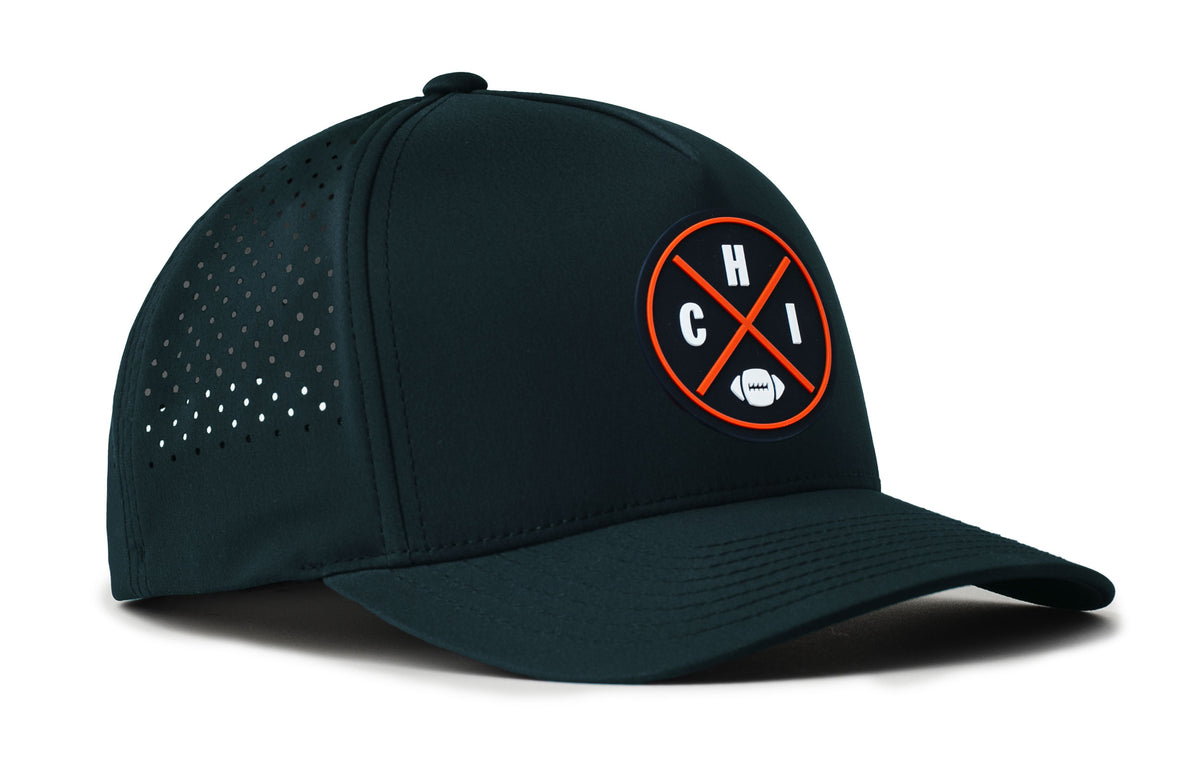 navy performance 5-panel hat viewed from the right side, showcasing a bold navy and orange pvc patch prominently displayed on the front