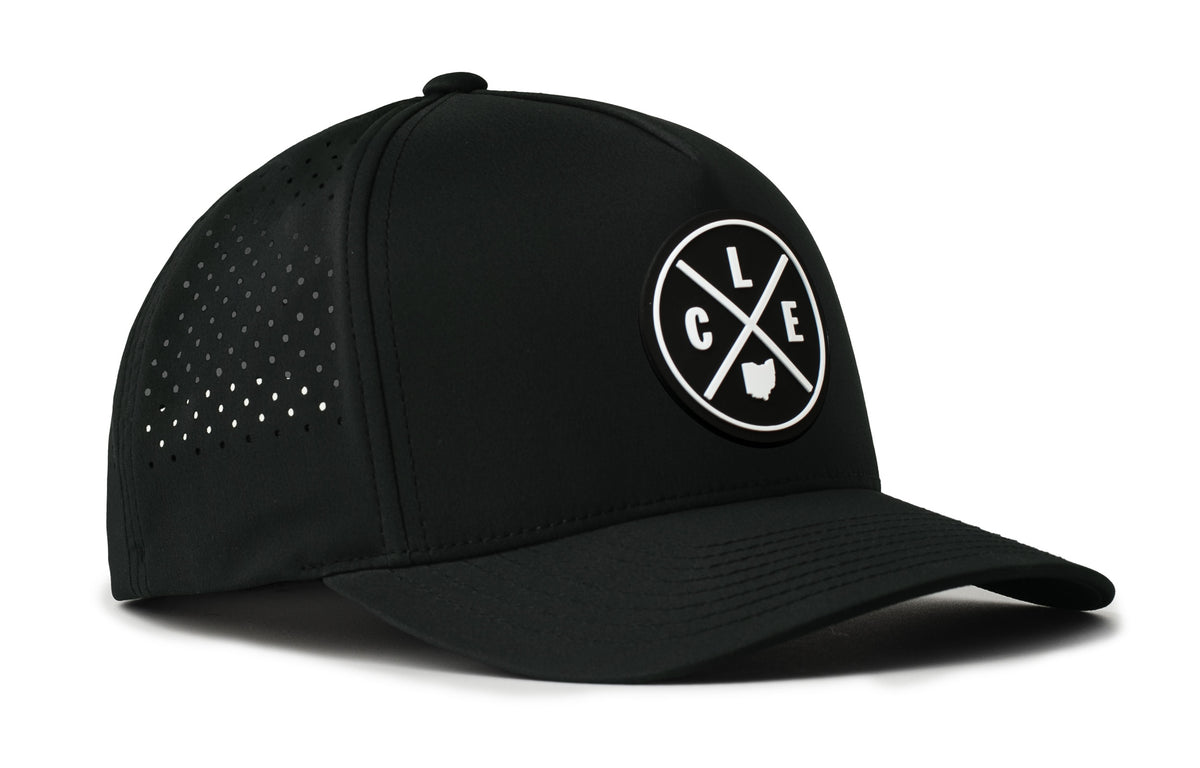 black trucker hat viewed from the right side, showcasing a bold black and white pvc patch prominently displayed on the front