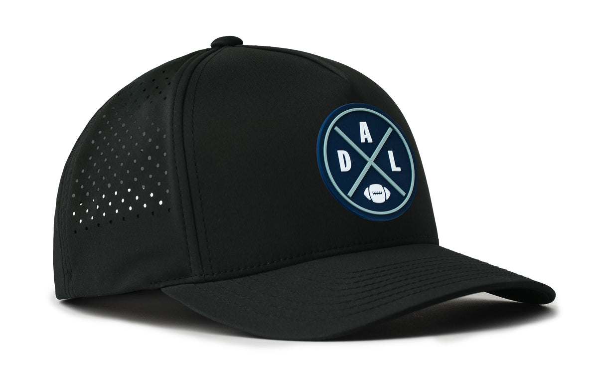 black trucker hat viewed from the right side, showcasing a bold navy and gray pvc patch prominently displayed on the front