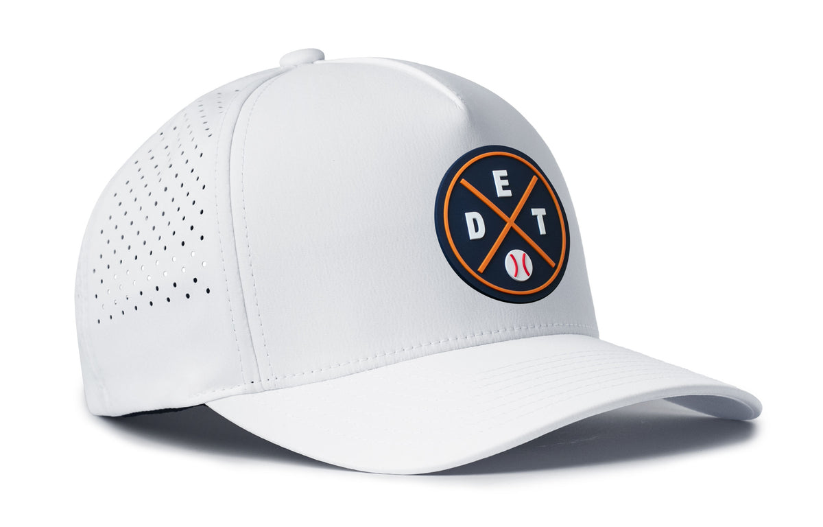 white performance 5-panel hat viewed from the right side, showcasing a bold navy and orange pvc patch prominently displayed on the front