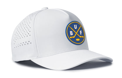 white performance 5-panel hat viewed from the right side, showcasing a bold royal and gold pvc patch prominently displayed on the front