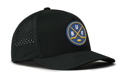 black performance 5-panel hat viewed from the right side, showcasing a bold royal and gold pvc patch prominently displayed on the front