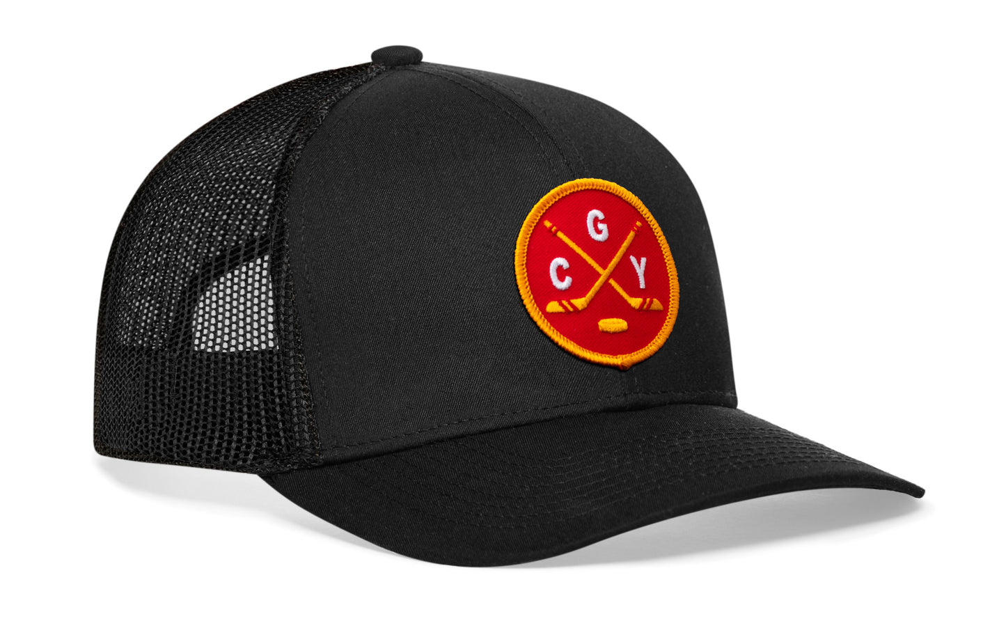 black trucker hat viewed from the right side, showcasing a red and gold hockey embroidered X patch prominently displayed on the front