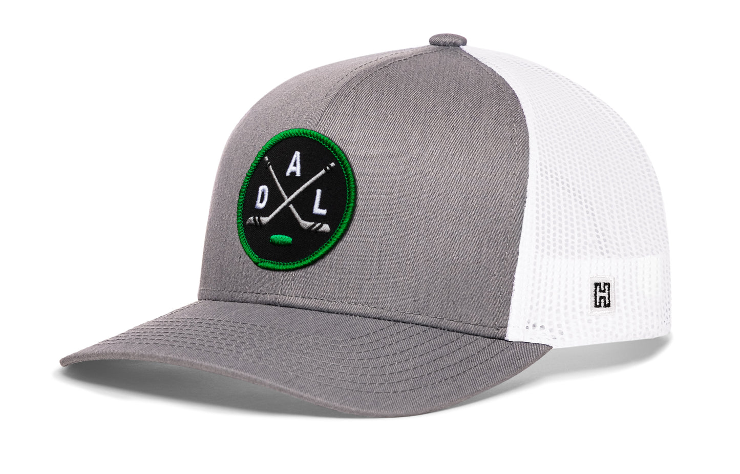Dallas hockey trucker hat, gray-white snapback showing Haka brandmark on left side mesh.
Rep Dallas hockey.