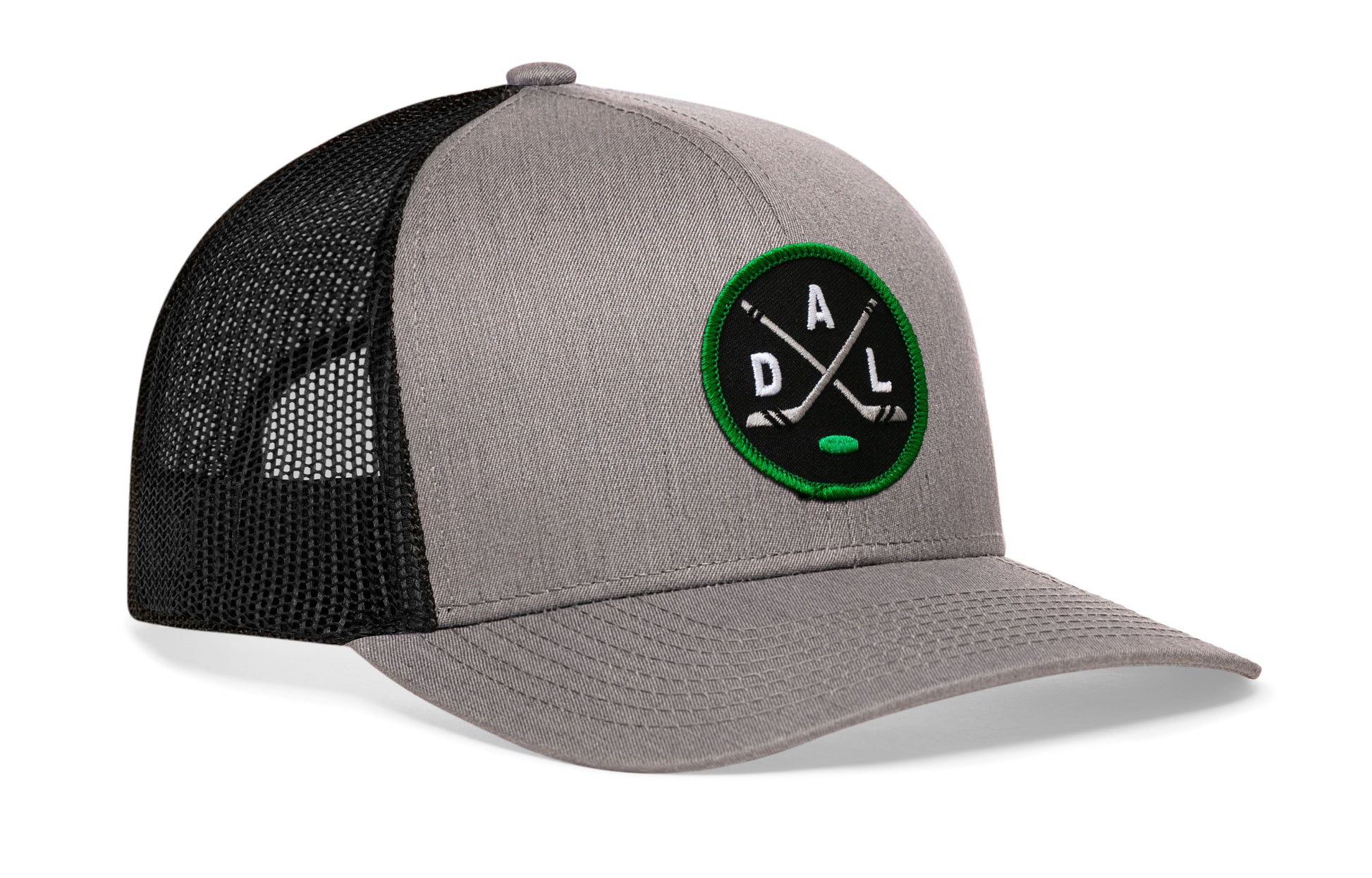 gray-black trucker hat viewed from the right side, showcasing a bold black, green and gray embroidered X patch prominently displayed on the front