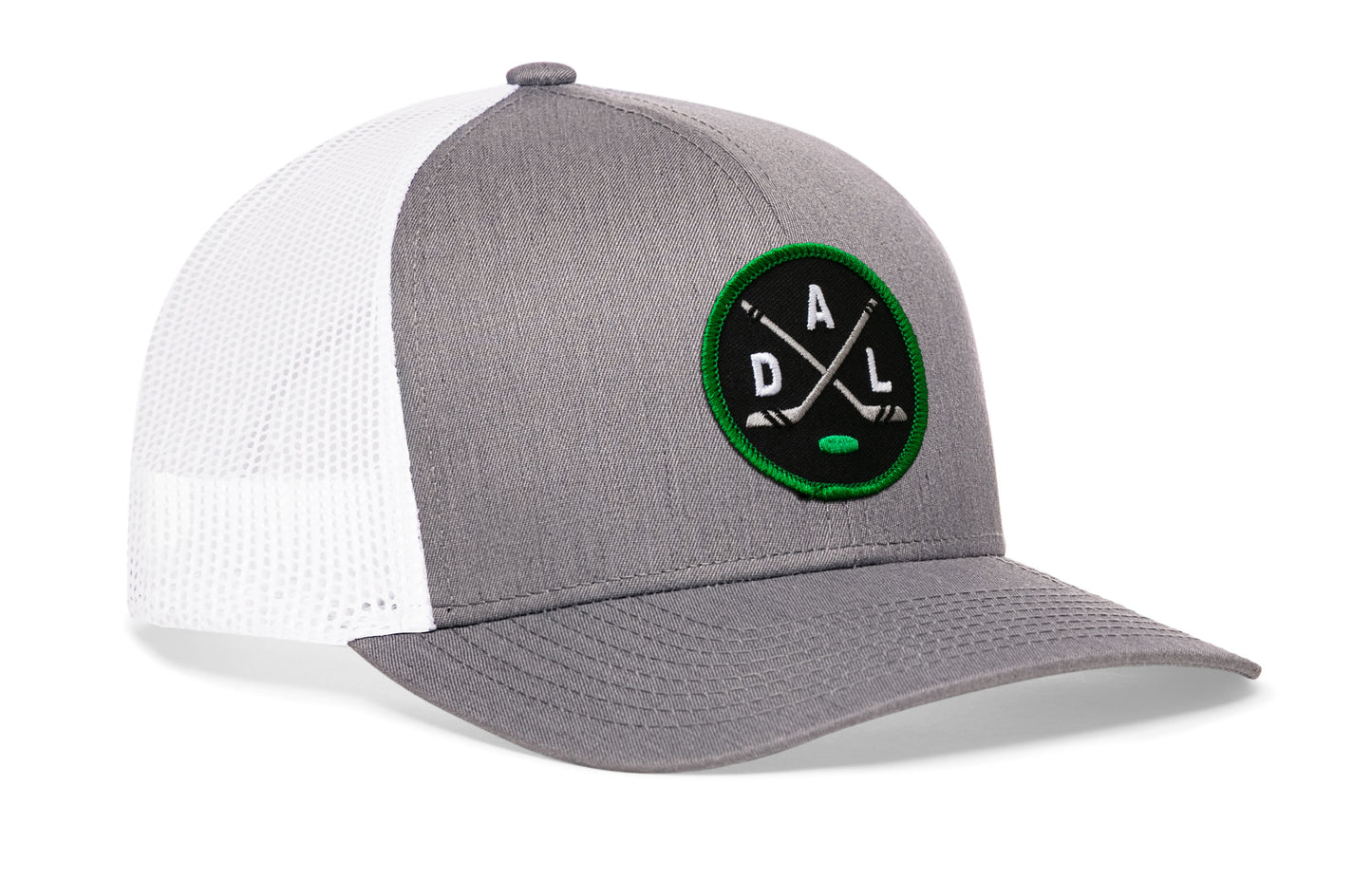 gray-white trucker hat viewed from the right side, showcasing a bold black, green and gray embroidered X patch prominently displayed on the front
