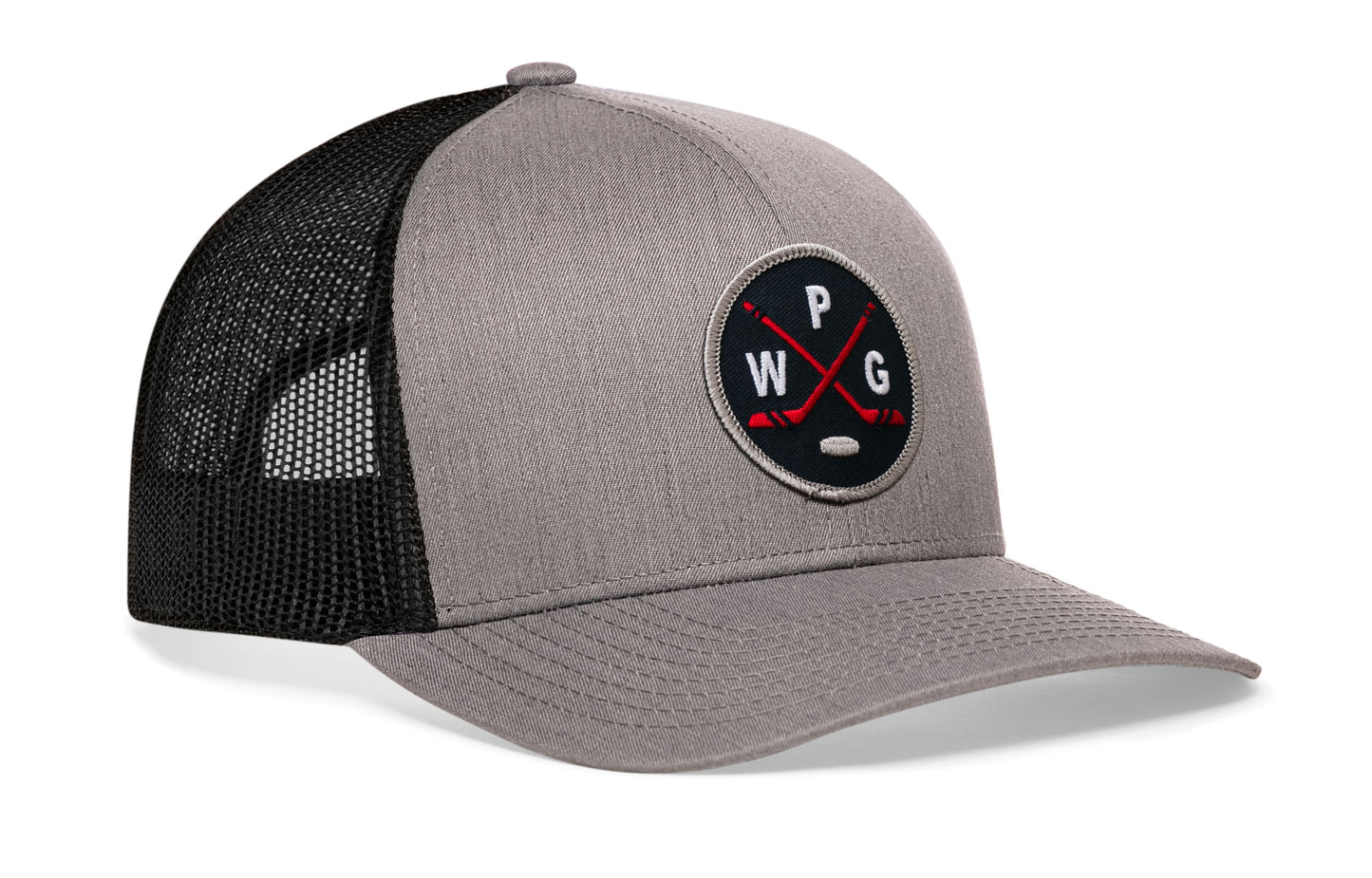 gray-black trucker hat viewed from the right side, showcasing a bold navy, red and gray embroidered X patch prominently displayed on the front