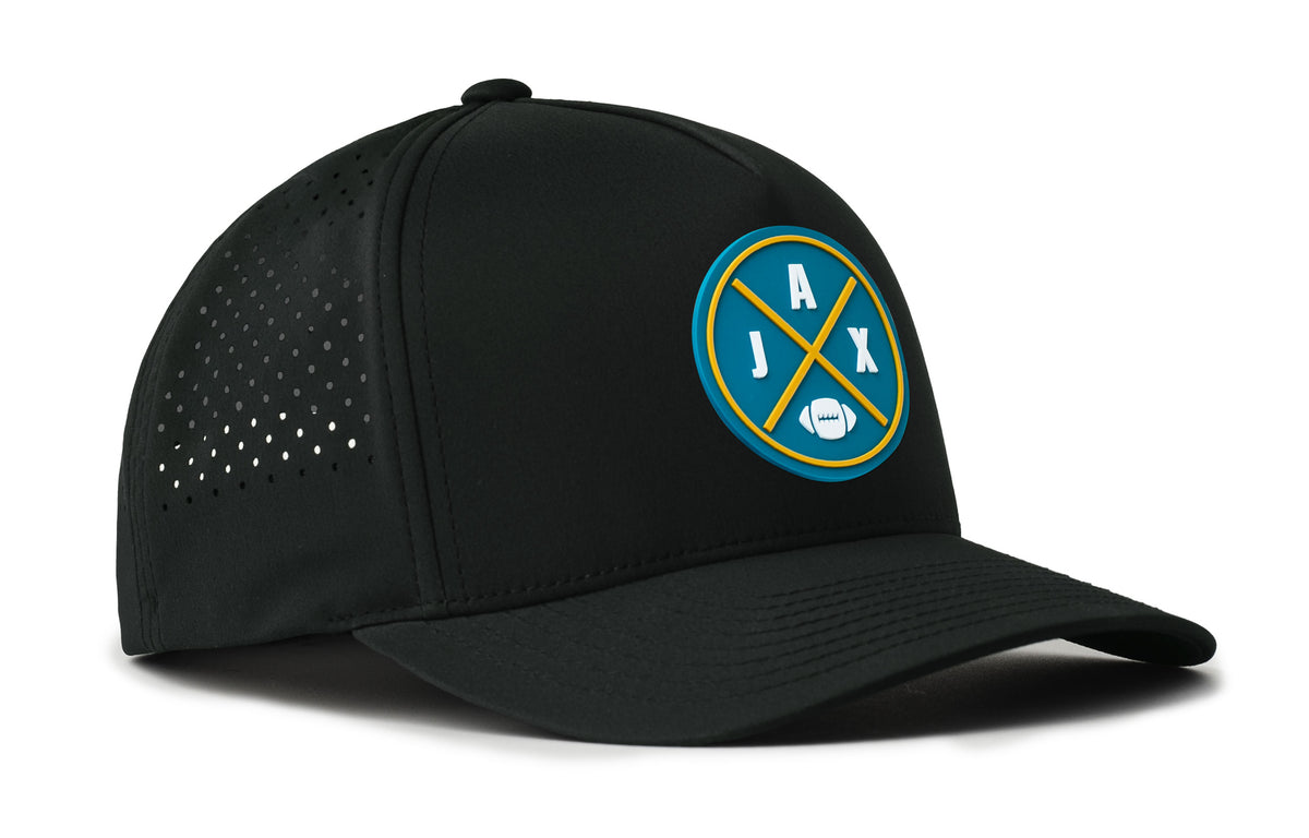 black performance 5-panel hat viewed from the right side, showcasing a bold teal and gold pvc patch prominently displayed on the front