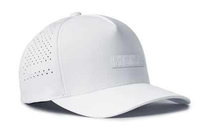 white performance 5-panel hat viewed from the right side, showcasing a bold white on white pvc patch prominently displayed on the front