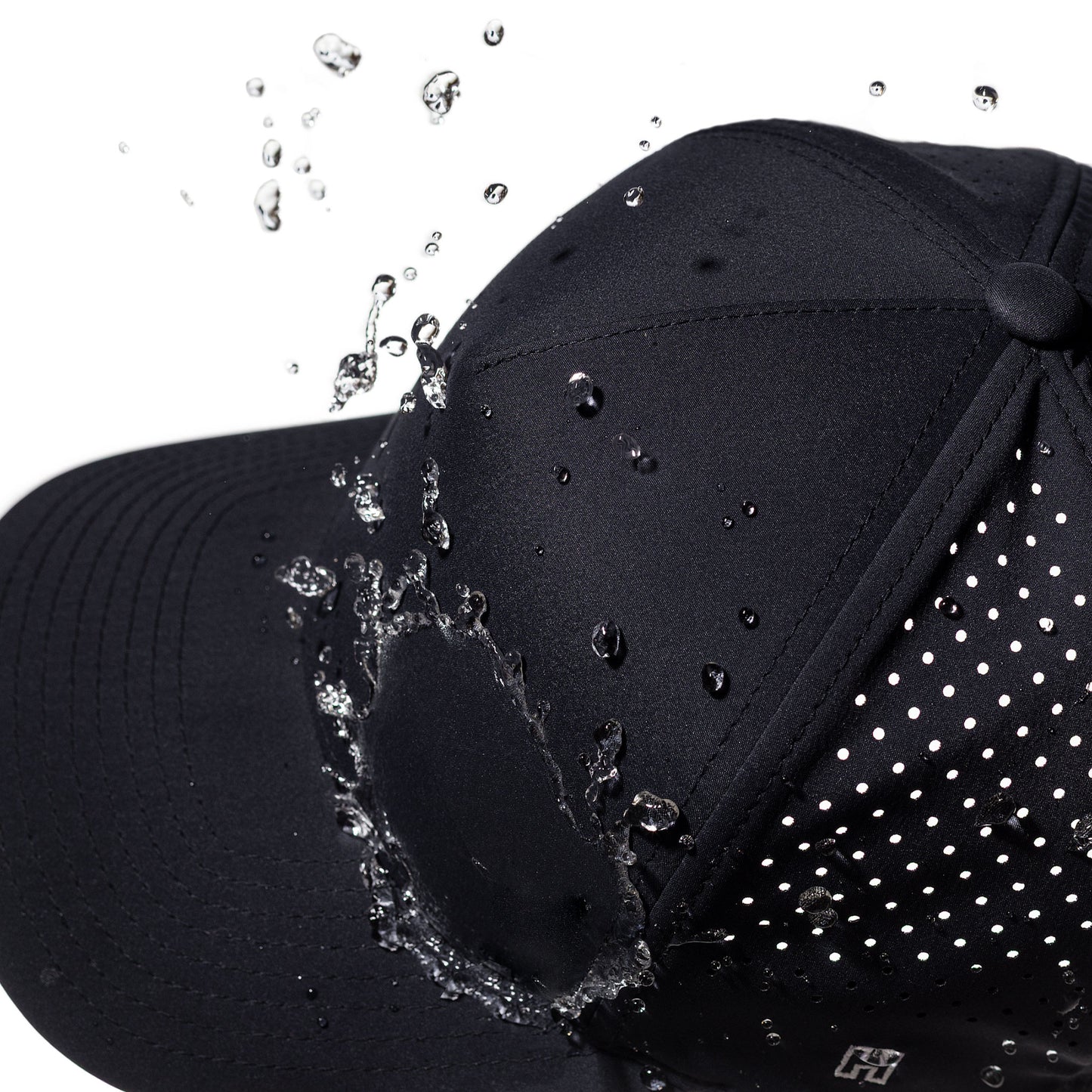 Navy performance hat with water droplets splashing onto it against a white background