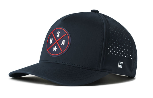 USA X Performance 5-Panel Hat, navy snapback showing Haka brandmark on left side of cap.