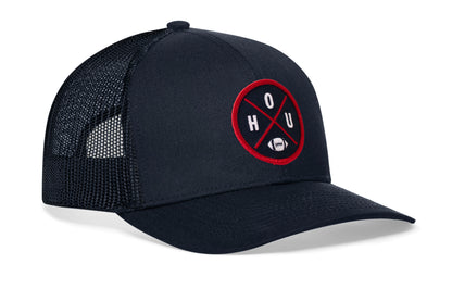 navy trucker hat viewed from the right side, showcasing a bold navy blue and red embroidered X patch prominently displayed on the front