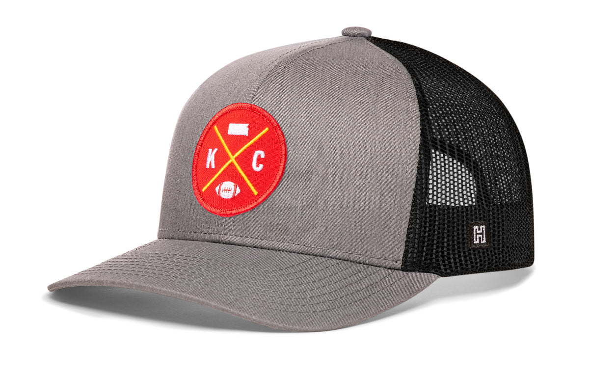 Kansas City Football Trucker Hat, gray-black snapback showing Haka brandmark on left side of cap.